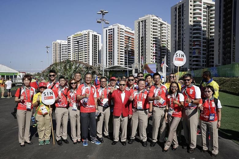 Chef de mission Low Teo Ping (centre, in red jacket) and some members of the 25-strong Singapore contingent at the Games Village in Rio de Janeiro, Brazil, yesterday after the welcome ceremony. Not all the Singapore athletes were present, as some wer