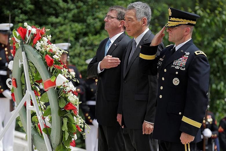 PM Lee, with US Defence Secretary Ash Carter (left) and US Army Major-General Bradley Becker, at the Tomb of the Unknown Soldier in Arlington National Cemetery on Monday.