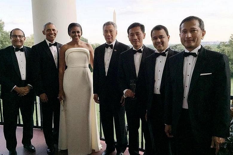 Mr Obama and his wife Michelle with PM Lee and members of the Singapore team - (from left) Minister for Trade and Industry (Industry) S. Iswaran, Acting Minister for Education (Higher Education and Skills) Ong Ye Kung, MP Christopher de Souza and For