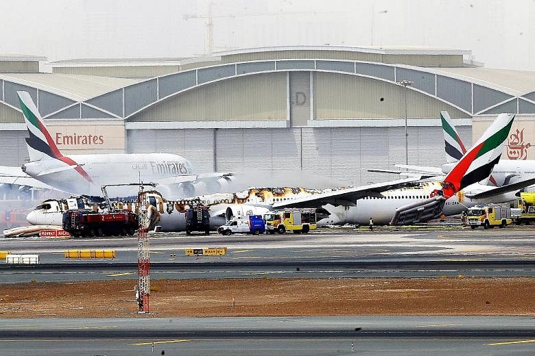 The scene after the Boeing 777-300 crash-landed at Dubai International Airport yesterday. There were 282 passengers and 18 crew members on board Flight EK521 from Thiruvananthapuram, capital of the Indian state of Kerala. Officials said one firefight