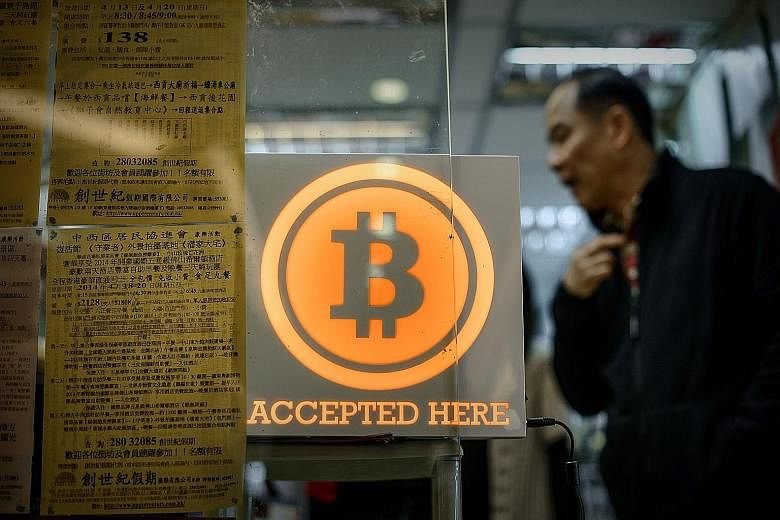 A shop in Hong Kong displaying a sign saying it accepts bitcoins. The value of the often-volatile currency plunged more than 20 per cent yesterday after bitcoin exchange Bitfinex discovered hackers had taken 119,756 bitcoins, or about $87.2 million a
