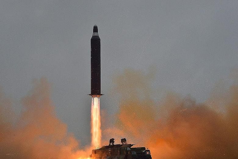 An undated photo from North Korea's state news agency showing a surface-to- surface medium long-range strategic ballistic rocket being launched at an undisclosed location in the country. Pyongyang yesterday fired a ballistic missile that flew about 1