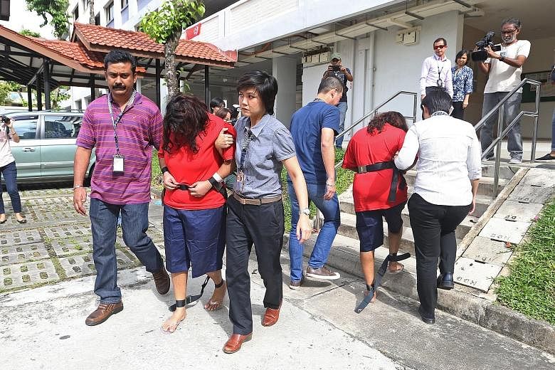 Police officers taking Gaiyathiri (left) and her mother Prema to their home in Bishan for investigations yesterday. The two women are accused of killing their Myanmar maid, Ms Piang Ngaih Don, some time between July 25 and 26. They were arrested last