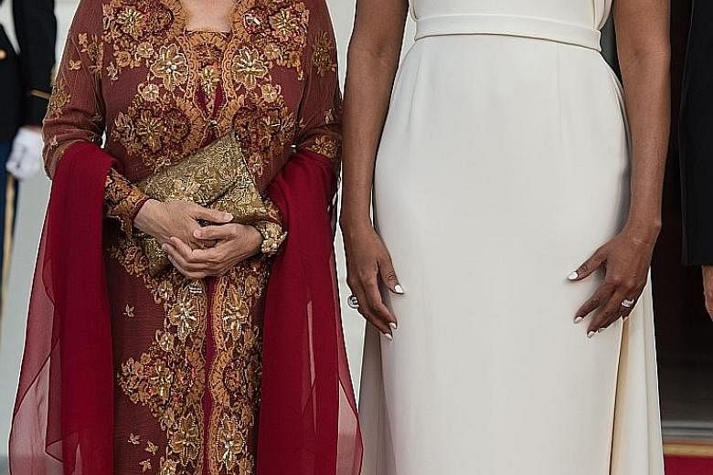 United States First Lady Michelle Obama with Ms Ho Ching, wife of Singapore Prime Minister Lee Hsien Loong, before the White House state dinner on Tuesday.