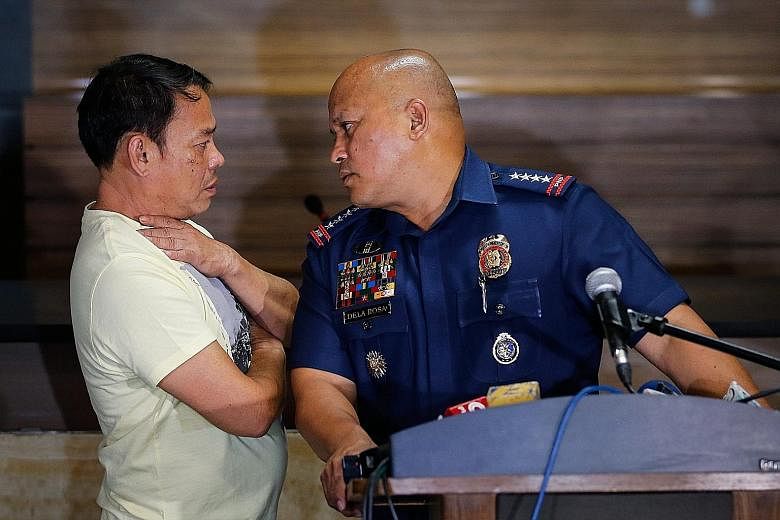 Alleged drug lord Rolando Espinosa (left) with police chief Ronald dela Rosa, after surrendering on Tuesday. President Duterte threatened to have the former mayor "shot on sight". Suspected kingpin Rolando Espinosa claims that his son Kerwin (left), 