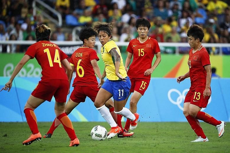 Cristiane (centre) surrounded by Chinese players during the first-round women's football match at the Olympic Stadium in Rio de Janeiro on Wednesday. She scored the final goal for Brazil in the 3-0 win.