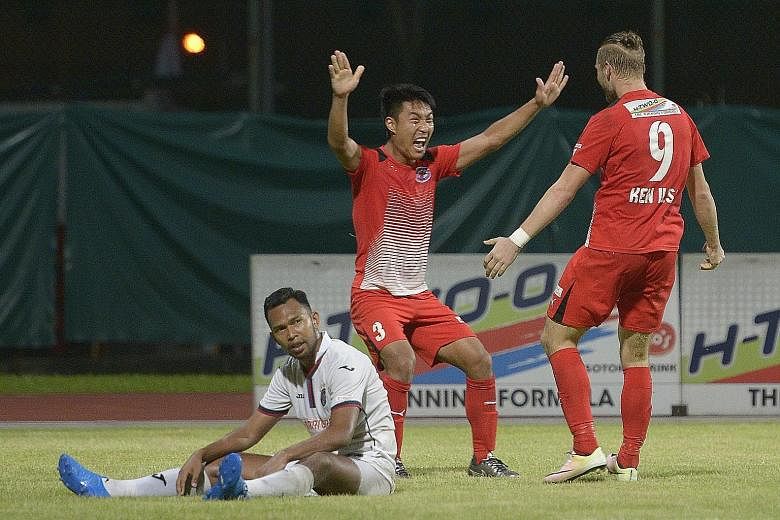 Song Ui Young (centre) celebrates his 65th-minute goal with his Home United team-mate Ken Ilso as a dejected Hafiz Osman of the Warriors looks on. The Protectors' duo accounted for all the goals in their 3-0 victory at Bishan Stadium yesterday.