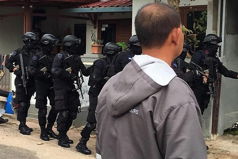 Indonesia's elite counter- terrorism unit Densus 88 carrying out a raid in Batam. Six members of a little-known terror cell called Katibah GR, or Cell GR, were arrested yesterday.