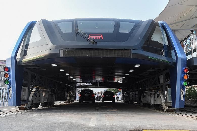 The first test run of the bus, which arcs over two lanes of traffic, was carried out on Tuesday in Qinhuangdao. Questions were asked about how it would turn; its 2m clearance which is too low for large vehicles; and how it would deal with drivers cha