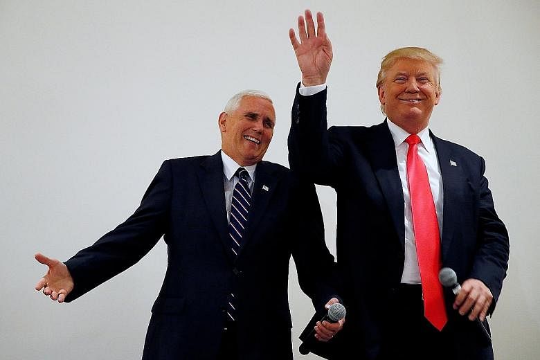 Mr Trump (right), here with his running mate Mike Pence, is facing urgent calls to stabilise his candidacy and declining poll numbers.