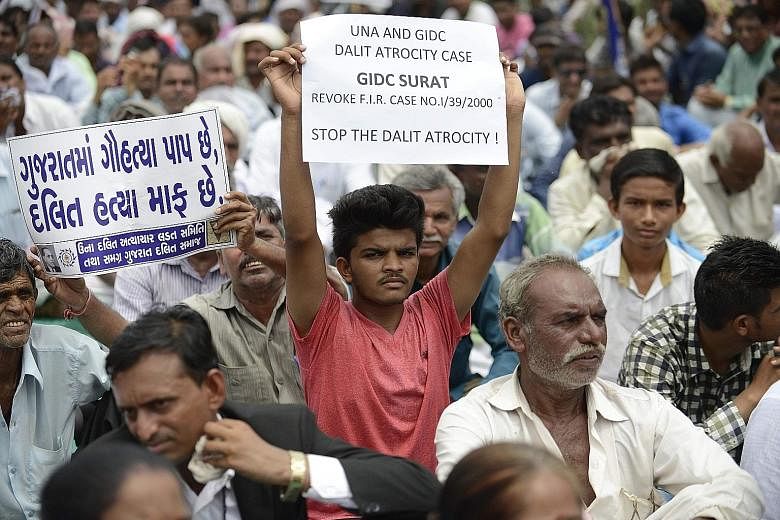 Protesters rallying in Ahmedabad on July 31 against the vigilante attack on four Dalit youths caught skinning a dead cow in Una, Gujarat. On social media, activists have been urging Dalits to take a solemn pledge to refuse to do some of their traditi