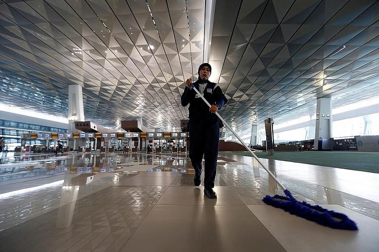 A worker cleaning the new Terminal 3 at Soekarno-Hatta International Airport in Jakarta. It will open on Tuesday after nearly two months of delays due to blind spots at some of its aprons and power supply issues.