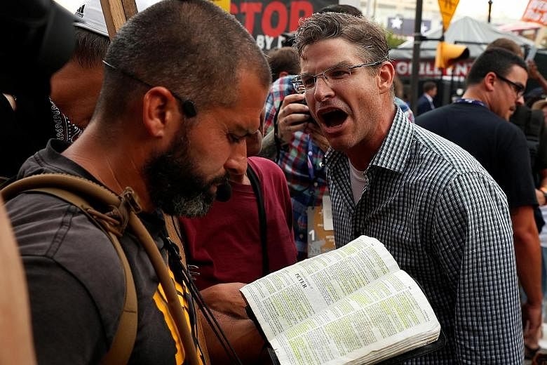 A Trump protester showing his displeasure at a man reciting religious scripture outside the Republican National Convention in Cleveland, Ohio, last month.