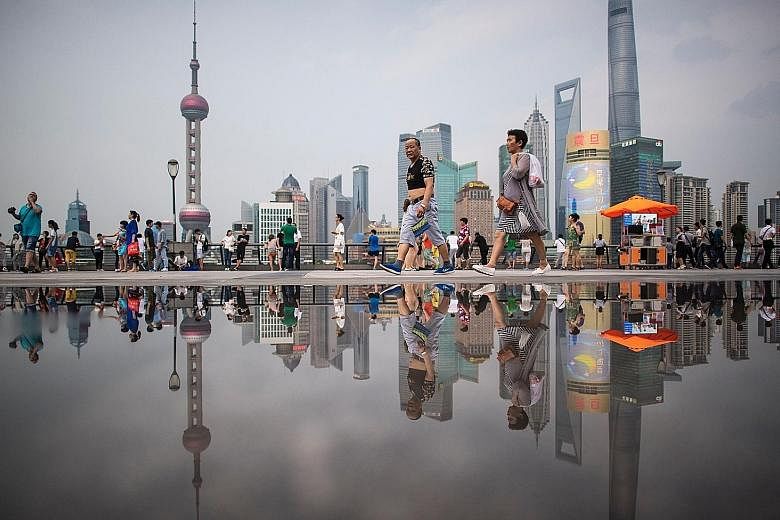 The Bund in Shanghai, overlooking the financial district of Pudong in the Chinese city. Market watchers remain divided on the outlook for China, which will release financial and economic data this week.