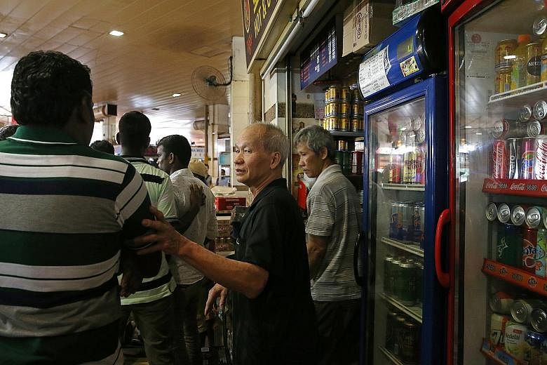 A stallholder at Tekka Food Centre informing patrons that he cannot sell alcohol after 6pm. Before this, customers could purchase and consume alcohol at the premises from 6am till midnight on Sundays, but the hours have now been shortened to 6pm.