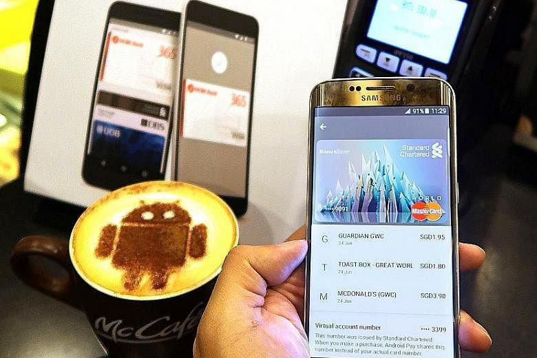 A customer using Google's Android Pay. Security and privacy concerns are cited as the main reasons for the slow sign-up rate for such e-wallet services.