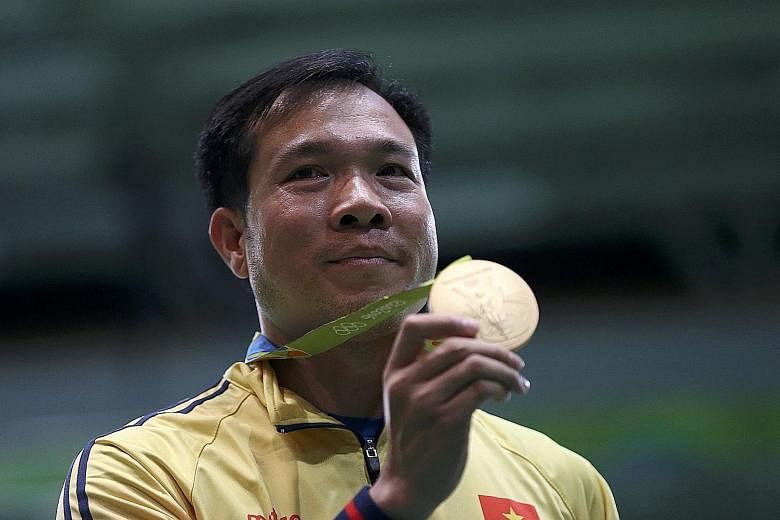 Vietnamese shooter Hoang Xuan Vinh (left) and Thai weightlifter Sopita Tanasan won South-east Asia's first two gold medals.