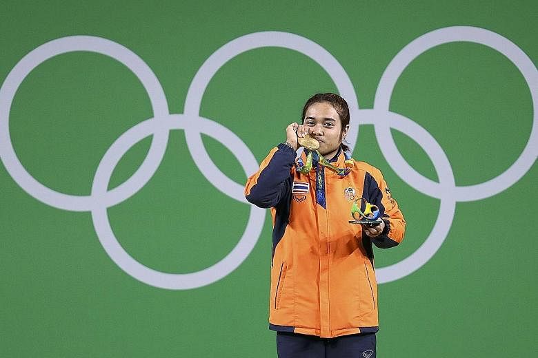Vietnamese shooter Hoang Xuan Vinh (left) and Thai weightlifter Sopita Tanasan won South-east Asia's first two gold medals.