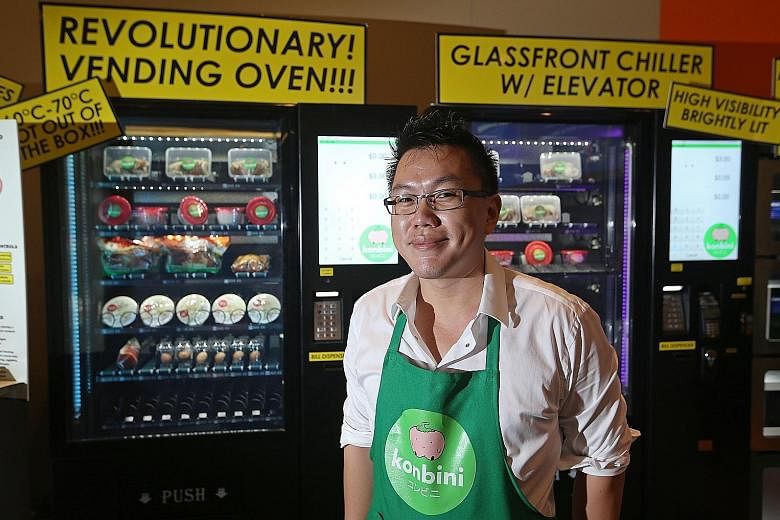 Mr Jing Quek of Konbini with a "vending oven", which maintains a temperature of 60 to 70 deg C, optimal for slow cooking food. A raw egg put into the machine, for example, comes out soft-boiled. At the VendCafe in Block 320C Anchorvale Drive are (fro