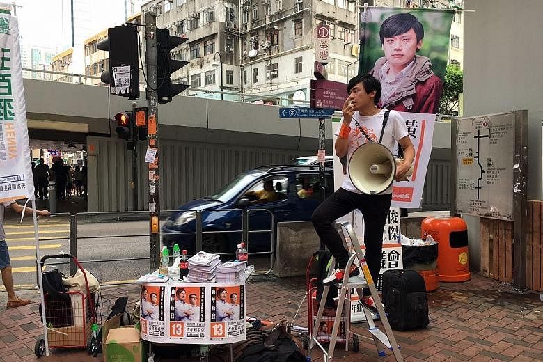 Localist party Youngspiration spokesman Kenny Wong Chun Kit campaigning in the streets in Hong Kong's Tsuen Wan district.