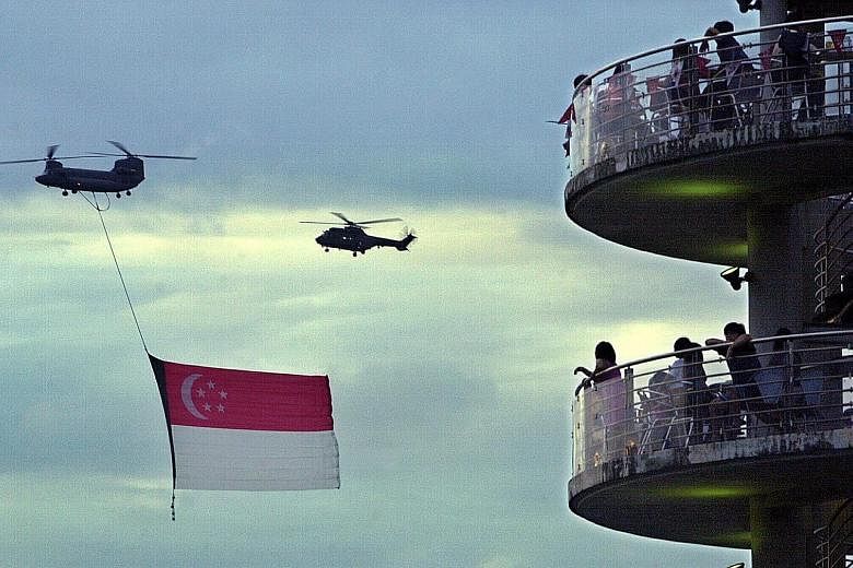Spectators viewing the fly-past of the state flag at the Tanjong Rhu lookout tower in 2001. They were treated to a spectacular fireworks finale.