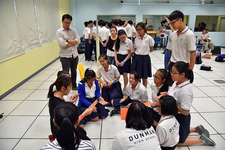 Gateway Entertainment's Mr Wan (far left), who suggested at an SGfuture dialogue that a role-playing game be created to educate students on what to do during a crisis, tried out some game scenarios with Dunman High students last month.