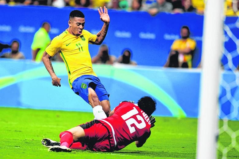 Brazil's Jesus Gabriel is thwarted by Iraq goalkeeper Mohammed Hameed during their 0-0 draw. The hosts must beat Denmark tomorrow or risk a humiliating knockout in the group stage.