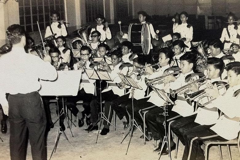 Mr Chiang with a baritone horn - the instrument he played at the 1966 National Day Parade - in St Gabriel's Secondary School. To ensure punctuality, he and others had stayed overnight at the school and slept on tables. A then 15-year-old Bernard Chia