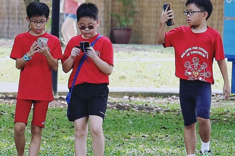 A group of boys on a Pokemon Go quest at East Coast Park. Activities were held at various venues in conjunction with the game. Gaming firm Razer sponsored Singapore's first PokeCrawl along Orchard Road yesterday, which began at Ion Orchard and ended 