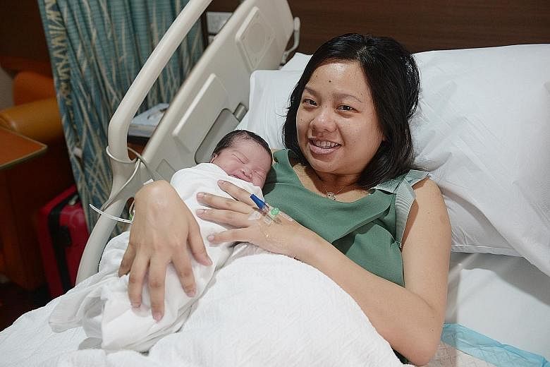 1SEC AFTER 12.00AM: Toh Xiu Hui (above) is born at Mount Alvernia Hospital. Her mother Wong Ying Ying says she is glad "everyone will always remember and celebrate her birthday". 12.03AM: The third baby (right) is born at KK Women's and Children's Ho