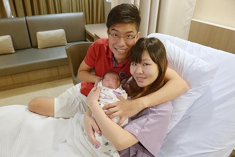 1SEC AFTER 12.00AM: Toh Xiu Hui (above) is born at Mount Alvernia Hospital. Her mother Wong Ying Ying says she is glad "everyone will always remember and celebrate her birthday". 12.03AM: The third baby (right) is born at KK Women's and Children's Ho