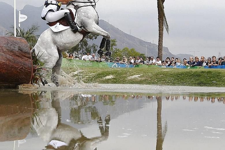 Gemma Tattersall of Britain attempting to cross one of the water obstacles during the preliminary individual eventing cross country at the Deodoro Olympic Equestrian Centre on Monday.