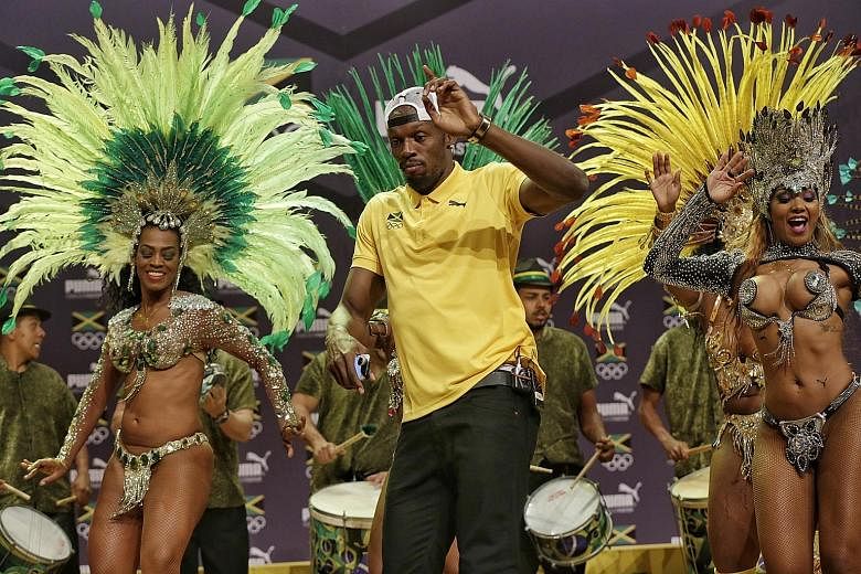 Jamaican sprinter Usain Bolt showing he can put on a show off the running track as well as he can on it, sashaying with samba dancers at the City of Arts in Brazil.
