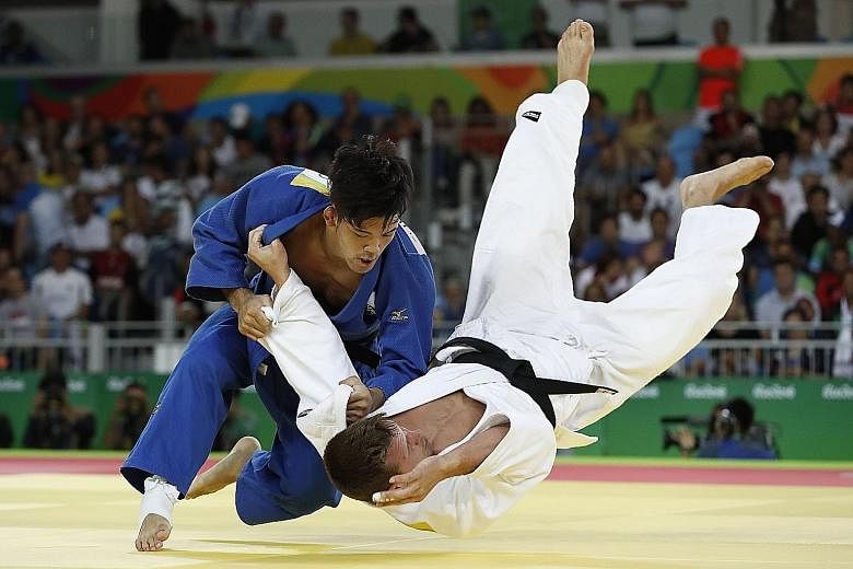 Japan's Shohei Ono (blue) competing with Belgium's Dirk van Tichelt in their men's -73kg semi-final. The Japanese said his victory in the final should inspire smaller judoka to achieve greater feats.