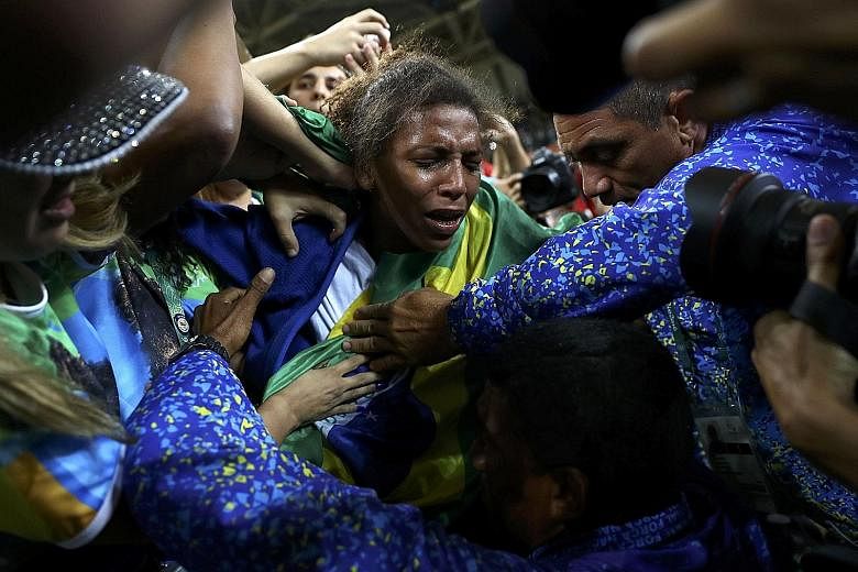Rafaela Silva, born and bred in Rio, weeping tears of joy as she celebrates her gold medal marking her rags-to-riches rise from favela to Olympic judo gold medallist.
