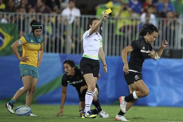 Australia's Emma Tonegato (left) making it 5-5 in the women's rugby sevens final. Two minutes later, New Zealand's Portia Woodman (above) was yellow-carded for a deliberate knock-on and Australia took advantage by going 10-5 up within seconds. They w