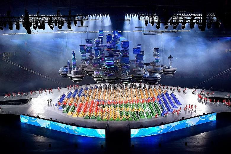 Rising high above the stage, an imposing "Sky City" prop of iconic landmarks and futuristic buildings projects Singapore's future skyline. The most challenging aerial prop in the show, it took nine months to design and two months to construct. Beneat