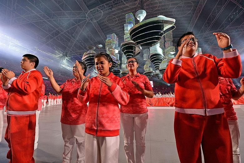 Fireworks light up the Kallang skyline, rounding off a night of celebration. Many parade-goers left the National Stadium early to catch a glimpse of the outdoor pyrotechnics, which were set off from the stadium's domed roof as well as from three barg