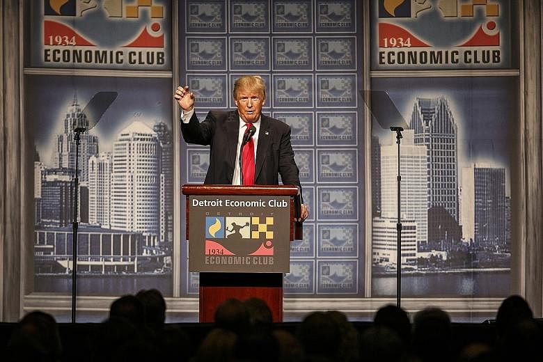 Mr Trump presenting his economic plans to the Detroit Economic Club on Monday. Although he chose the city in a clear appeal to the working-class at the centre of his political strategy, the economic policies he is planning to implement as president w