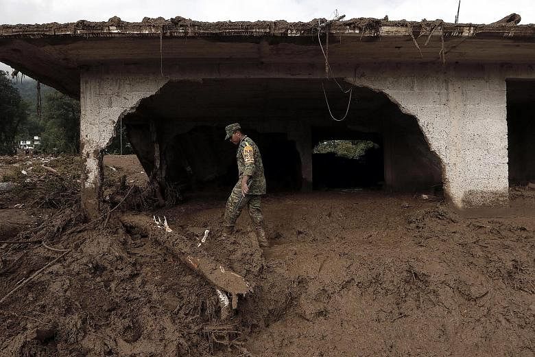 Hundreds of soldiers and rescue workers are searching for the missing after the remnants of tropical storm Earl triggered landslides in central Mexico that killed at least 45 people over the past few days. Trudging through mud that is sometimes up to