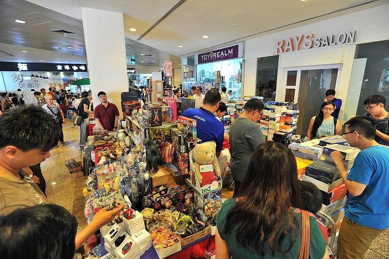 People checking out the toys, collectibles and antiques on sale at the flea market in China Square Central on Sunday. Mr Michael Poh, the organiser of the mall's popular flea market for the past 11 years, says there has been no official word on wheth