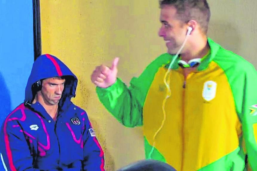 Michael Phelps' focus on winning was caught on camera on Monday before his 200m butterfly semi-final race (top). The American's facial expression was an instant hit on the Internet, with some fans producing memes that likened his intense stare to tha