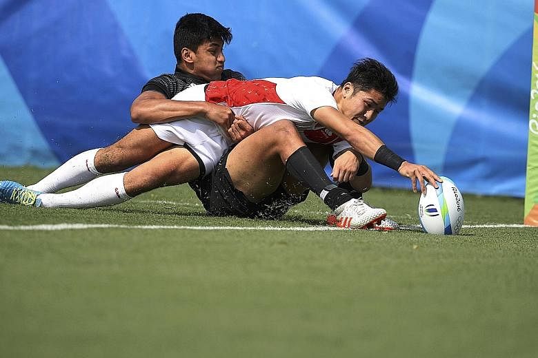 Kazushi Hano of Japan scoring a try during his side's 14-12 win over New Zealand while being tackled by Rieko Ioane. New Zealand coach Gordon Tietjens believes this result shows the gap between both teams has narrowed considerably.