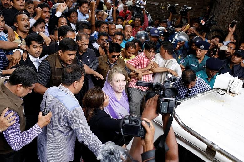 Khaleda Zia leaving the court in Dhaka yesterday after being granted bail in the latest charges against her. Her party says the cases have been fabricated and are aimed at keeping Zia, a bitter rival of Prime Minister Sheikh Hasina, under political p