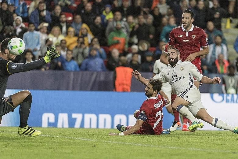 Dani Carvajal (in white) scoring the winning goal in Real Madrid's 3-2 extra-time victory against Sevilla in the Super Cup match in Trondheim, Norway on Tuesday.