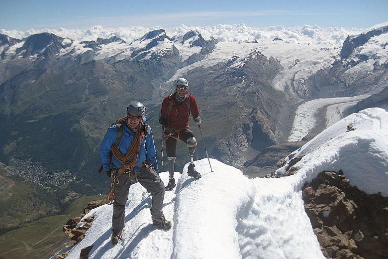 Quadruple amputee Jamie Andrew and a mountain guide in jubilant mood on top of the Matterhorn last Thursday.