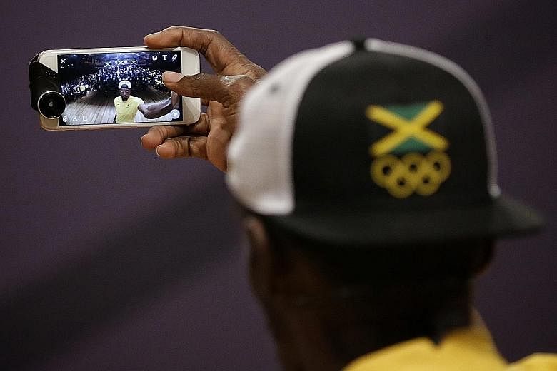 Jamaican star Usain Bolt taking a wefie with the media during a press conference held by the Jamaican Olympic Association at Cidade Das Artes on Monday.