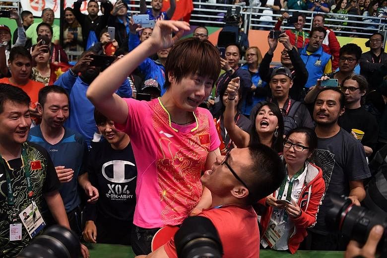 China's Ding Ning (in pink) celebrating with her supporters after beating compatriot Li Xiaoxia in their table tennis singles gold-medal match at the Riocentro venue on Wednesday. She had suffered a bitter loss to the same opponent in the London 2012