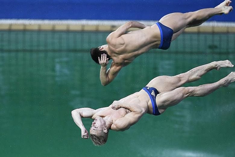 Britain's Jack Laugher and Chris Mears (top) plunging into the green waters of the diving pool. The organisers say too many people using it caused a drop in alkalinity.