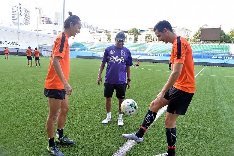Hougang coach K. Balagumaran cutting a happy figure as he watched midfielder Fumiya Kogure and striker Stipe Plazibat train at the Jalan Besar Stadium yesterday. He has built a base this year and sees a lot of potential in the team.